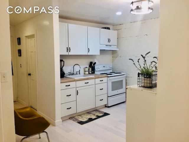 kitchen with a sink, light countertops, white cabinets, electric stove, and under cabinet range hood