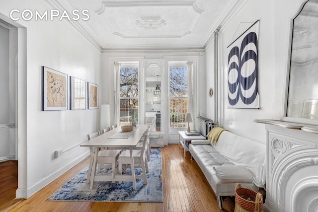 office with light wood finished floors, crown molding, and baseboards