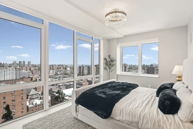 bedroom with a view of city and an inviting chandelier