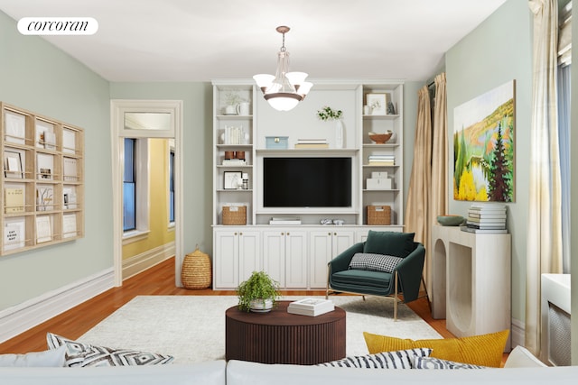living area featuring visible vents, light wood finished floors, baseboards, and a chandelier