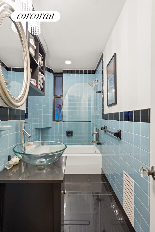 full bathroom with shower / bathtub combination, tile patterned flooring, visible vents, vanity, and tile walls