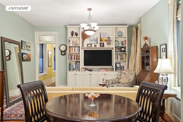 dining room with a chandelier, visible vents, and baseboards