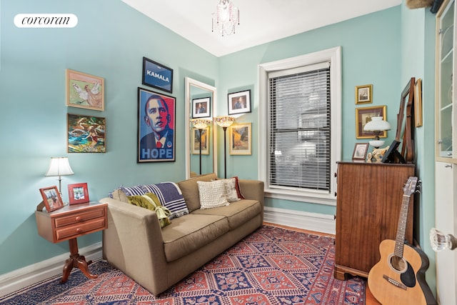 living room with visible vents, baseboards, and a notable chandelier