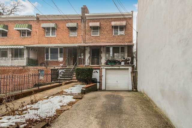 3828A Barnes Ave, New York City, NY 10467 - townhome / multi-family property with a garage, concrete driveway, brick siding, and a chimney