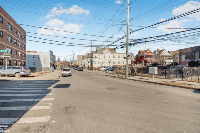 view of road featuring curbs, street lighting, and sidewalks