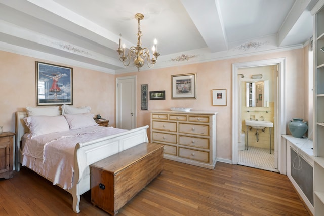 bedroom featuring connected bathroom, a sink, wood finished floors, beam ceiling, and an inviting chandelier