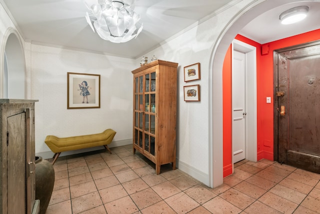 interior space featuring baseboards and arched walkways