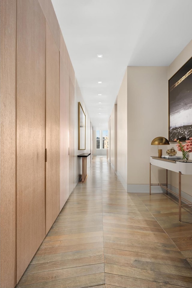 hallway featuring baseboards and light wood-style floors