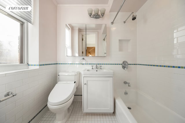 full bath featuring toilet, tile patterned flooring, bathing tub / shower combination, and tile walls