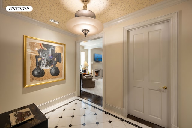 hallway featuring light tile patterned floors, baseboards, visible vents, and crown molding