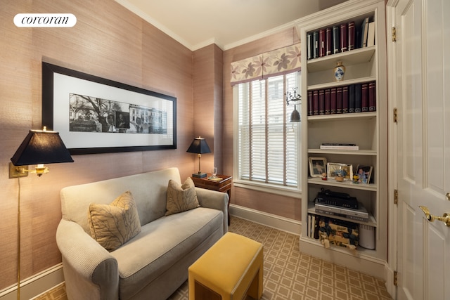 sitting room with crown molding and baseboards