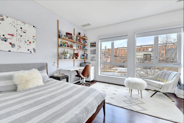 bedroom featuring visible vents and wood finished floors