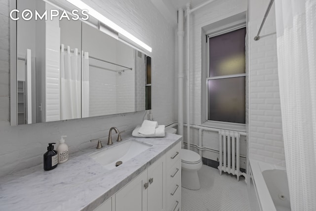 bathroom featuring radiator, toilet, tile patterned floors, vanity, and shower / tub combo