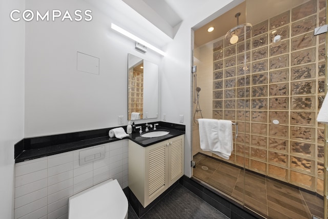 full bath featuring recessed lighting, a walk in shower, toilet, and vanity