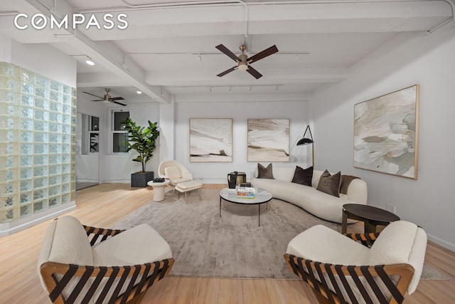95 Vandam St Unit 2R, New York City, NY 10013 - living area featuring a ceiling fan, beam ceiling, wood finished floors, and rail lighting