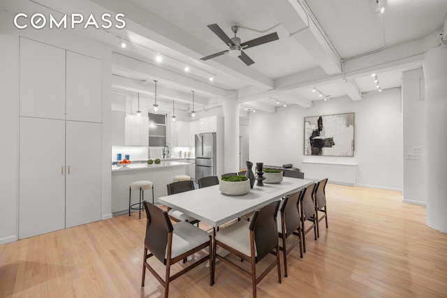 95 Vandam St Unit 2R, New York City, NY 10013 - dining room with light wood finished floors, ceiling fan, rail lighting, and beam ceiling