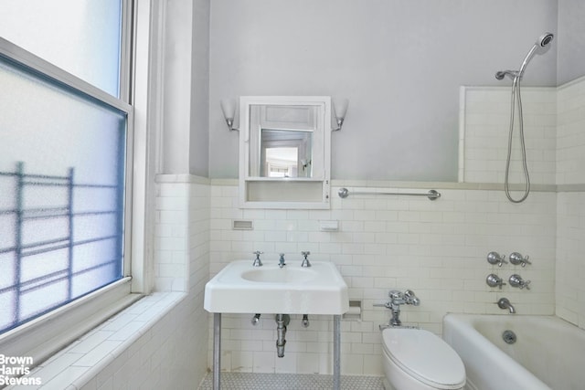 924 W End Ave Unit 21, New York City, NY 10025 - full bathroom featuring toilet, tile walls, shower / bath combination, a sink, and wainscoting