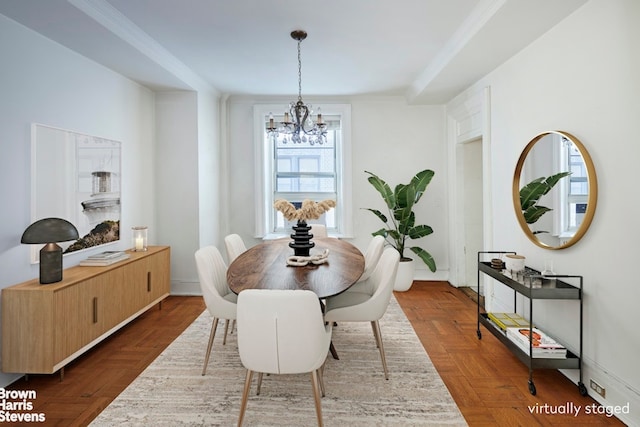 dining space featuring a chandelier and ornamental molding