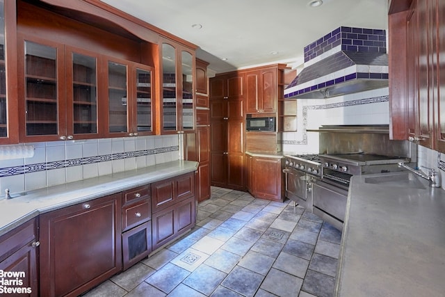 924 W End Ave Unit 21, New York City, NY 10025 - kitchen with black microwave, decorative backsplash, a sink, light countertops, and wall chimney range hood