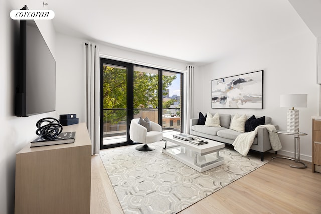 living area featuring light wood-type flooring and baseboards