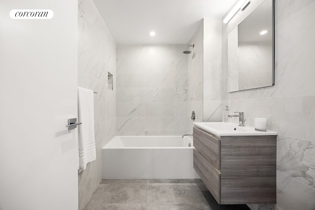 27-09 40th Ave Unit 3G, New York City, NY 11101 - full bath with tile walls, vanity, and shower / bathtub combination