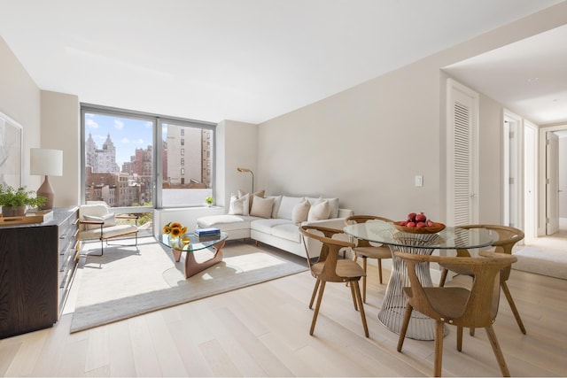 212 W 72nd St Unit 7J, New York City, NY 10023 - living area featuring light wood-style flooring and a view of skyline