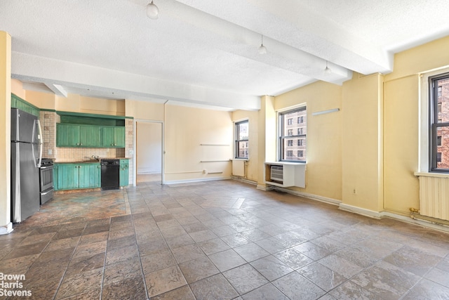 unfurnished living room featuring stone finish flooring, baseboards, a textured ceiling, and radiator heating unit