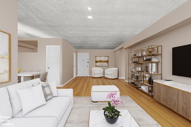 living room with a textured ceiling, light wood-type flooring, and baseboards