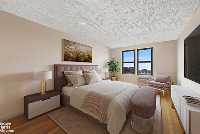 bedroom with light wood-style floors and a textured ceiling