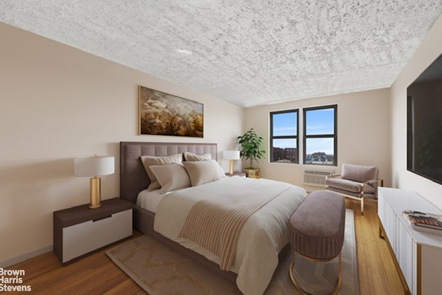 175-45 88th Ave Unit 6M, New York City, NY 11432 - bedroom with a textured ceiling, wood finished floors, and baseboards