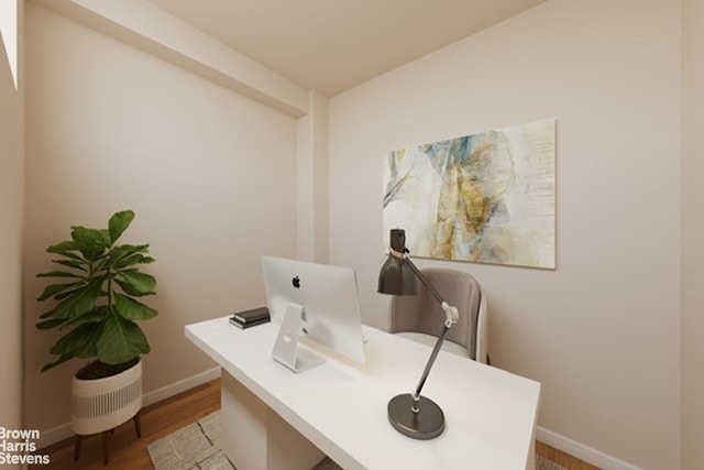 office area featuring baseboards and wood finished floors