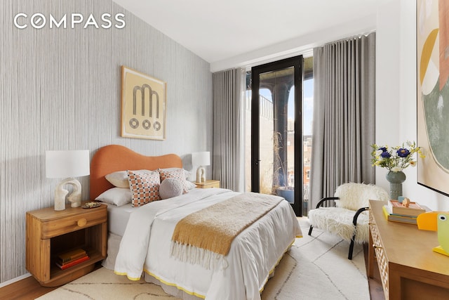 325 W Broadway Unit 7B, New York City, NY 10013 - bedroom featuring wallpapered walls, access to outside, and wood finished floors