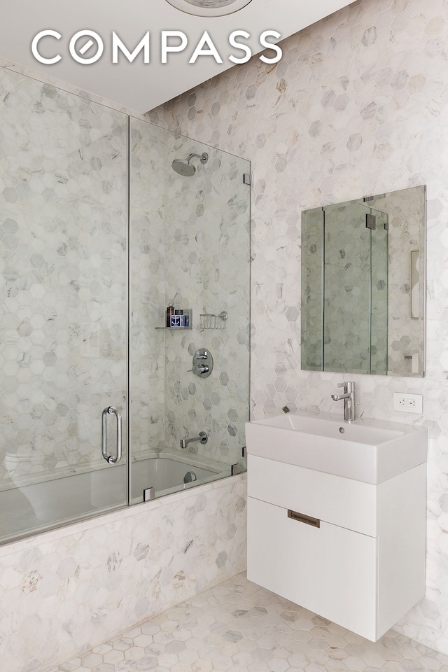 325 W Broadway Unit 7B, New York City, NY 10013 - bathroom with vanity, combined bath / shower with glass door, and tile patterned floors