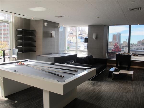 247 W 46th St Unit 1105, New York City, NY 10036 - playroom featuring plenty of natural light, a view of city, and pool table