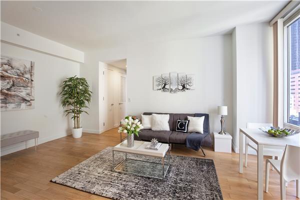 living area with a healthy amount of sunlight and light wood-type flooring
