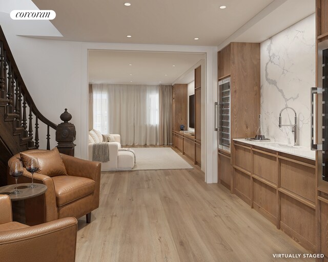 interior space featuring a skylight, vanity, wood finished floors, and recessed lighting