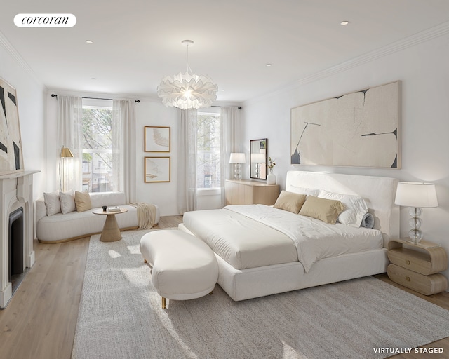 bedroom with light wood-style floors, multiple windows, visible vents, and crown molding