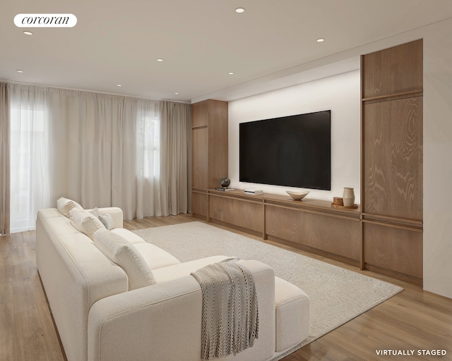 living area with visible vents, light wood-style flooring, and recessed lighting