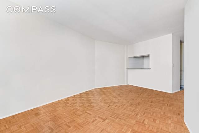 empty room featuring baseboards