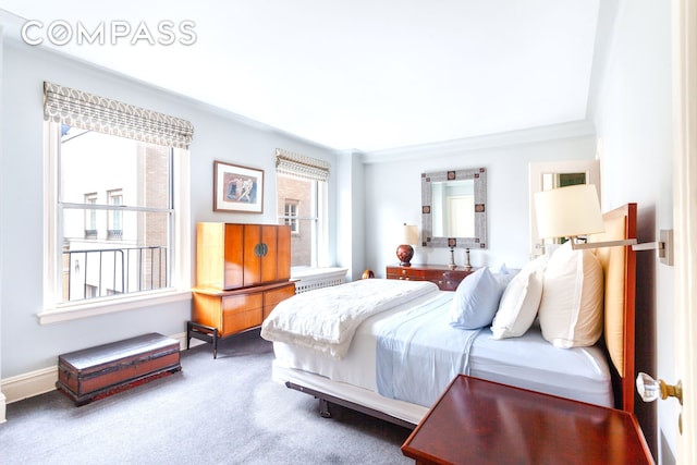 bedroom featuring carpet floors, ornamental molding, and baseboards