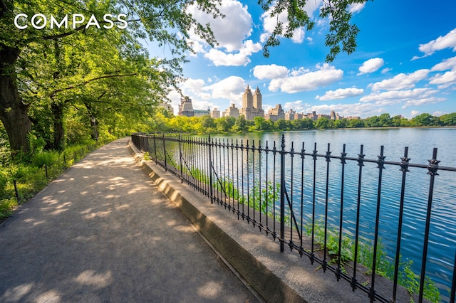 water view featuring a skyline view and fence