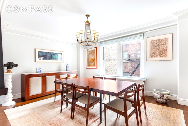 8 E 96th St Unit 7C, New York City, NY 10128 - dining space with crown molding, a chandelier, light wood-style floors, and baseboards