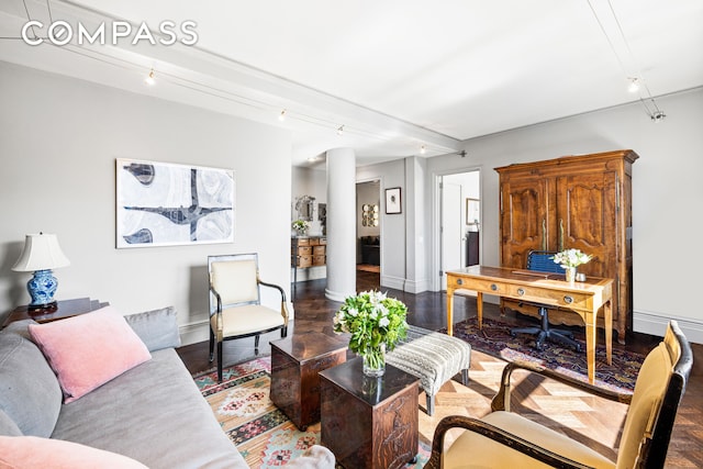 living area featuring baseboards and wood finished floors