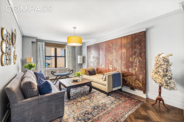 living area featuring baseboards and ornamental molding