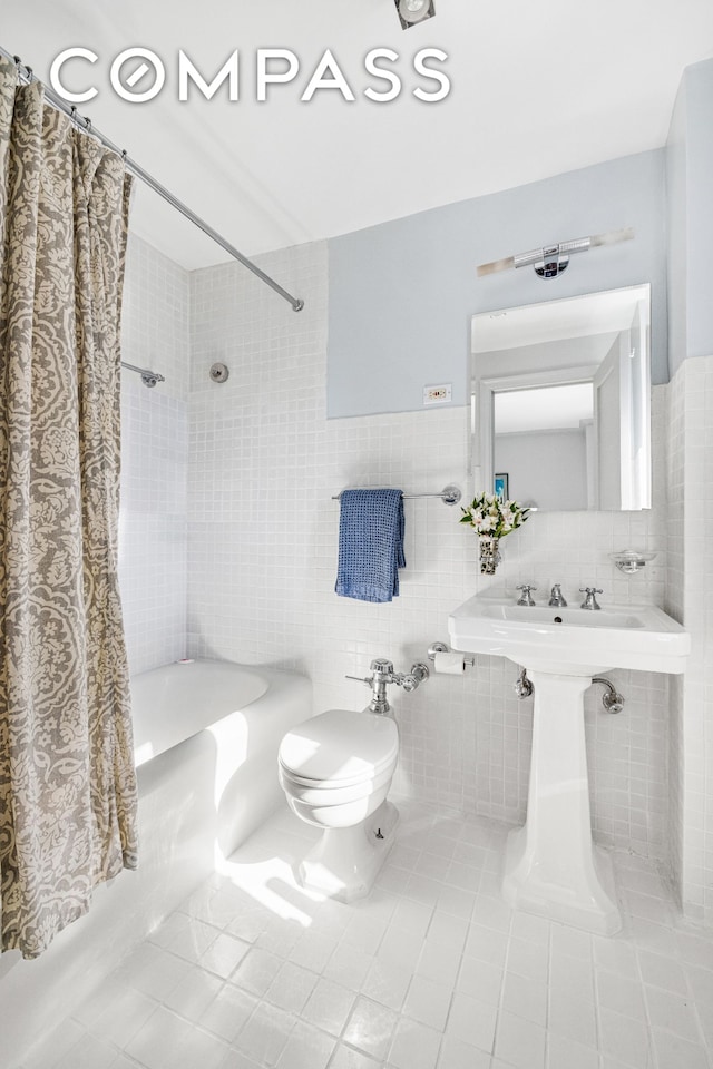 full bathroom with toilet, shower / bath combo with shower curtain, tile walls, and tile patterned floors