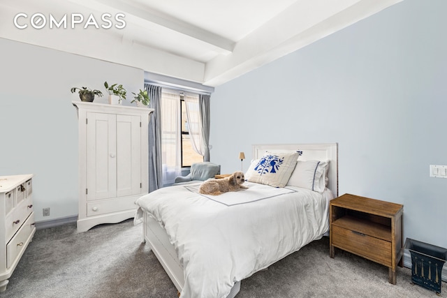 bedroom with carpet floors and beam ceiling