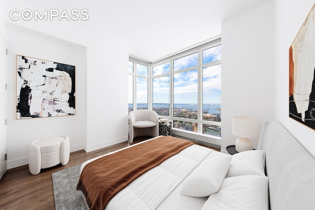 bedroom featuring baseboards and wood finished floors