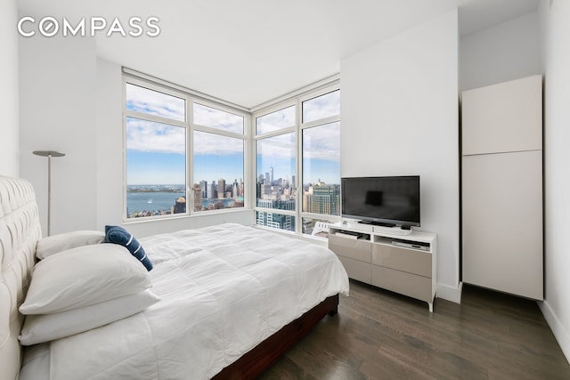 bedroom with dark wood-style flooring