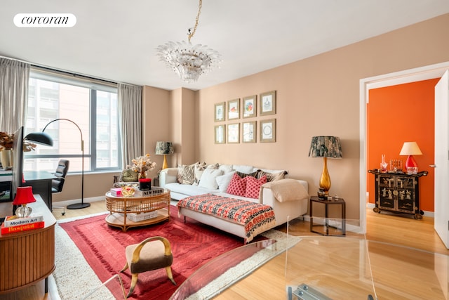 living area featuring baseboards, visible vents, and a notable chandelier