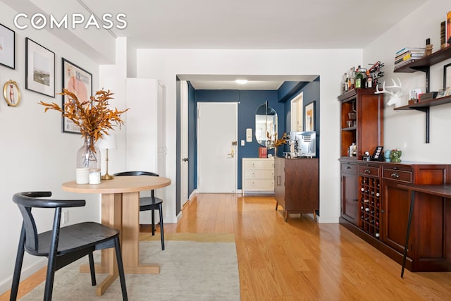 interior space featuring baseboards and light wood-type flooring